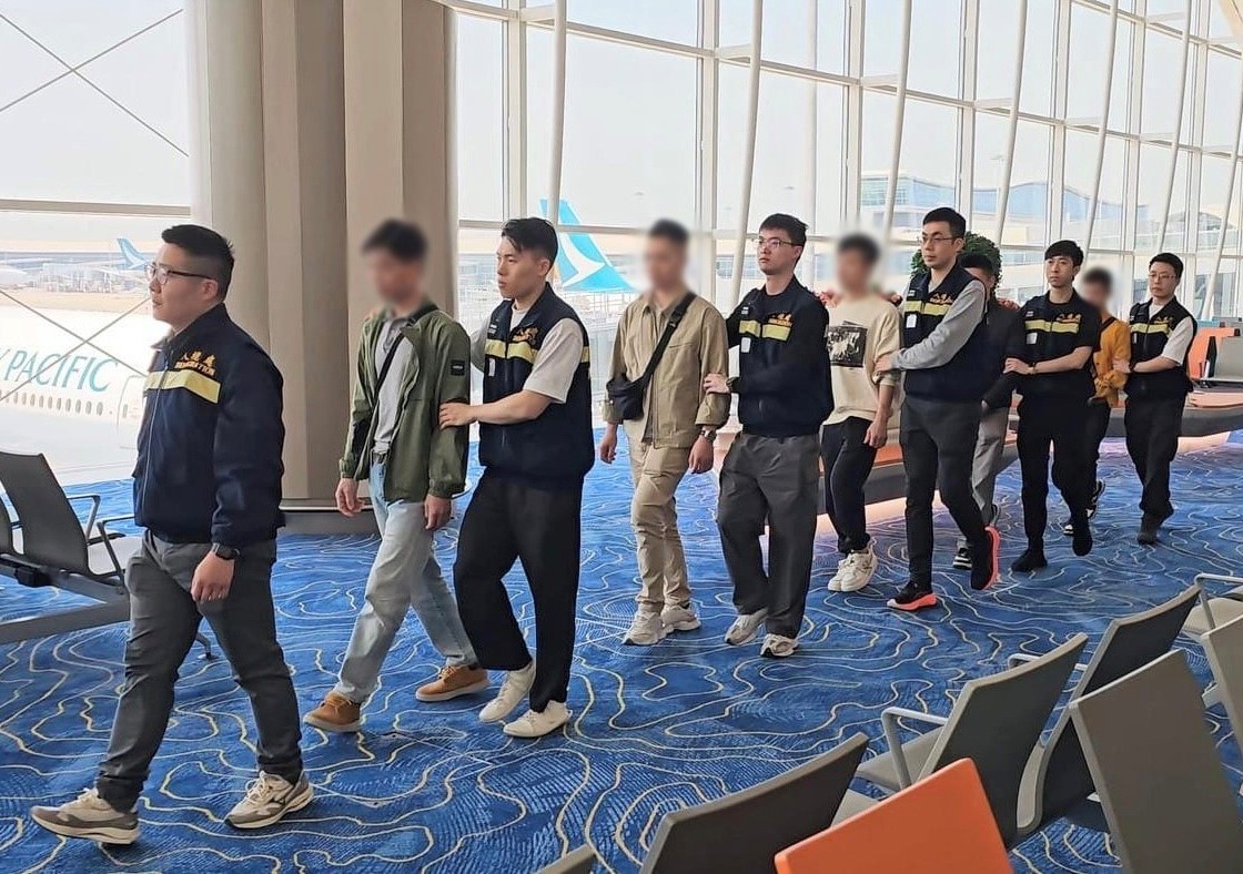 Photo shows removees being escorted by ImmD officers to depart from Hong Kong
