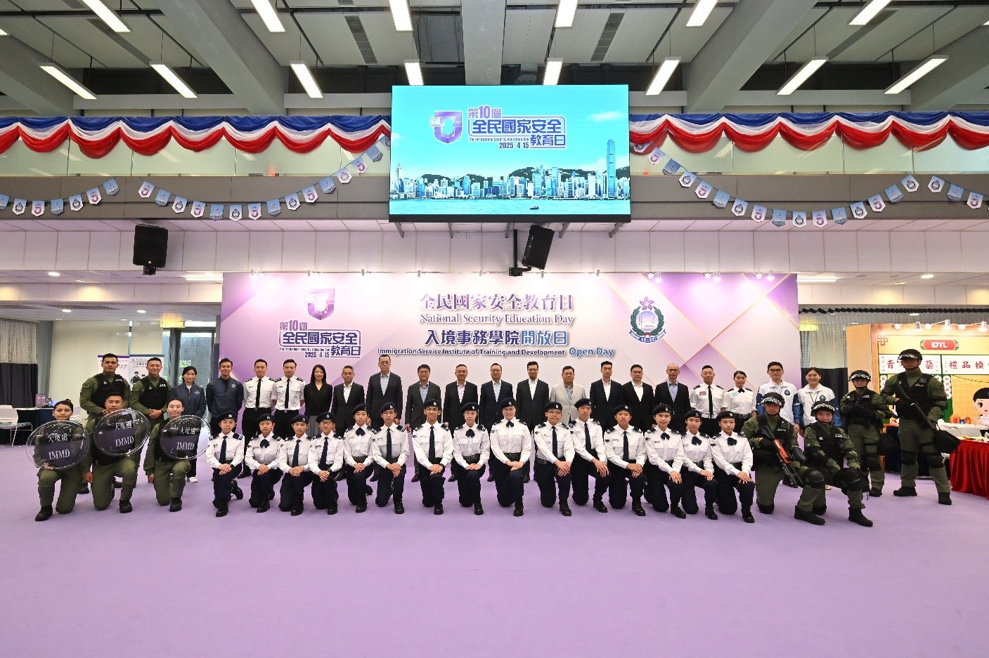 Photo shows the Secretary for Justice, Mr Paul Lam, SC (centre), accompanied by directorate officers of the Immigration Department, taking a group photo with members of the Immigration Service participating in the event