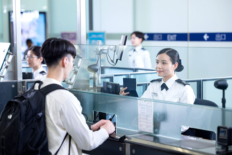 Officers of the department providing professional and quality immigration service for air passengers at the HKIA.