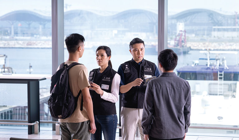 Officers of the department conducting spot checks on passengers' travel documents at the newly commissioned SkyPier Terminal.