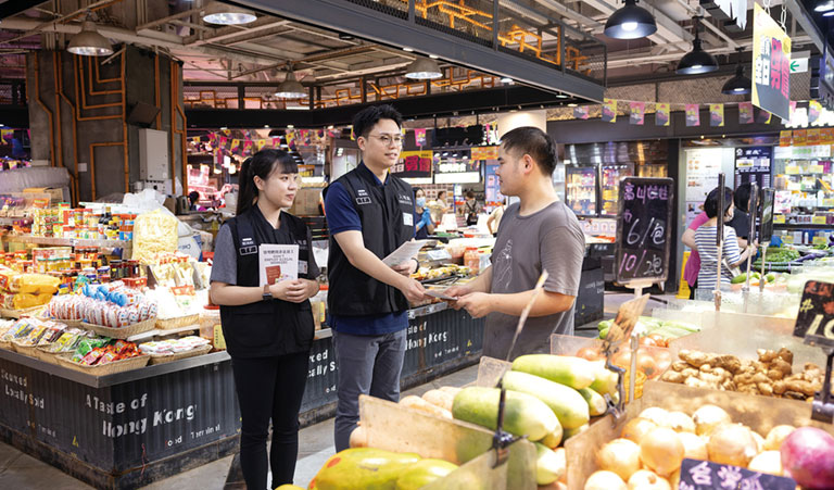 Immigration Task Force officers distribute 'Don't Employ Illegal Workers' leaflets to shop owners.